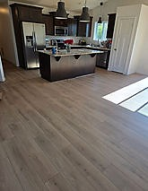 Luxury vinyl plank flooring in an open kitchen with island