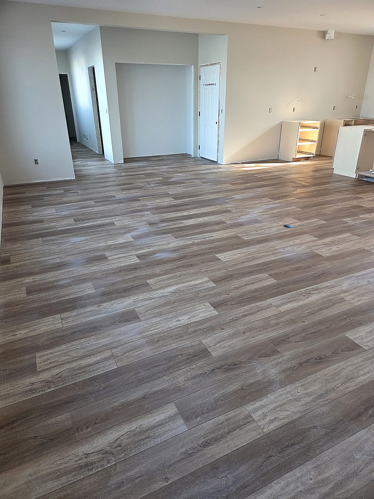 Gray wood-look plank flooring in a large open room