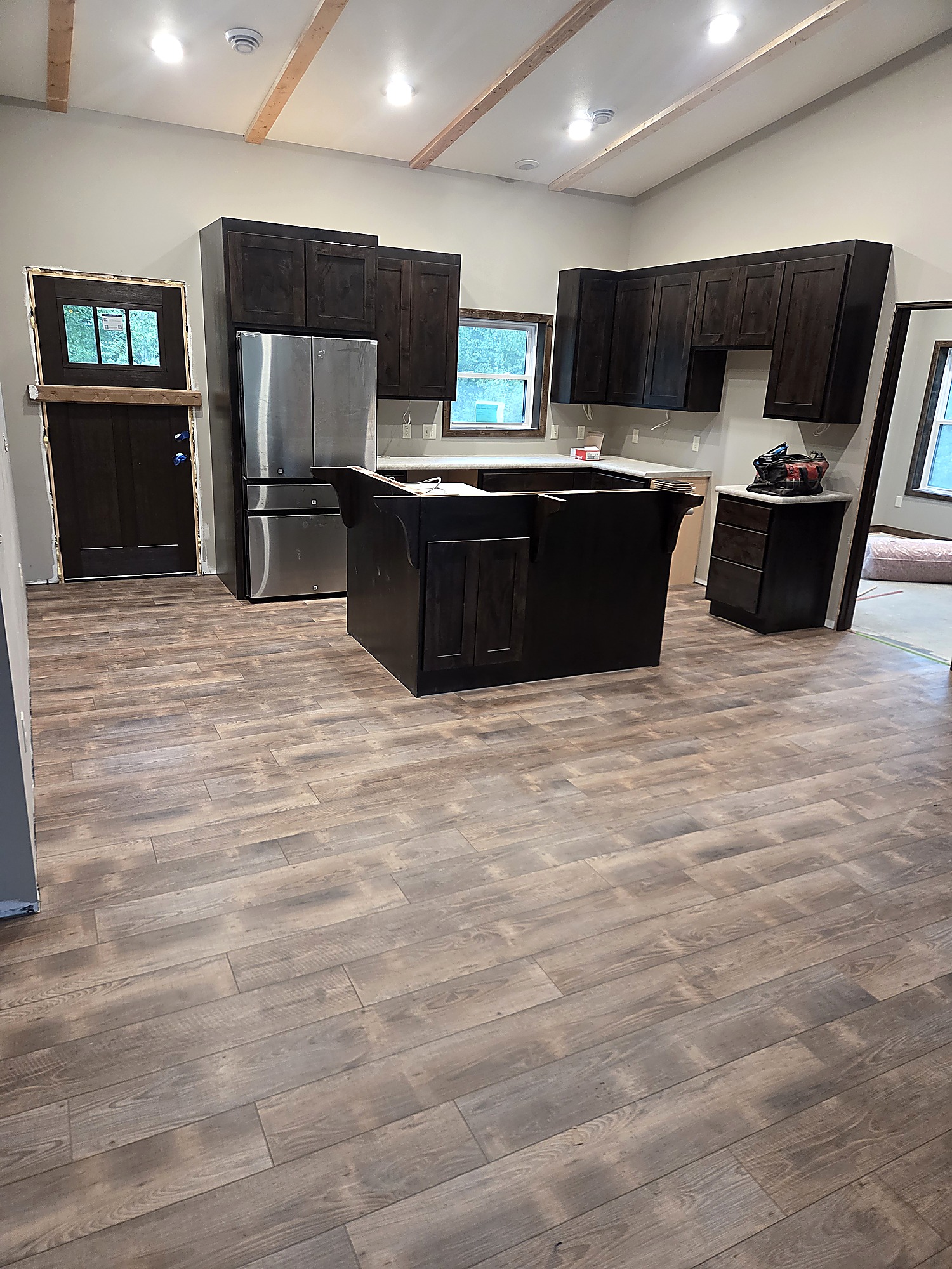 Wide-plank engineered hardwood flooring in an open room