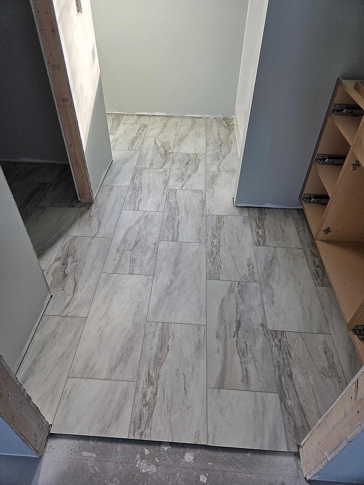 Marble-look flooring in a bathroom and closet area