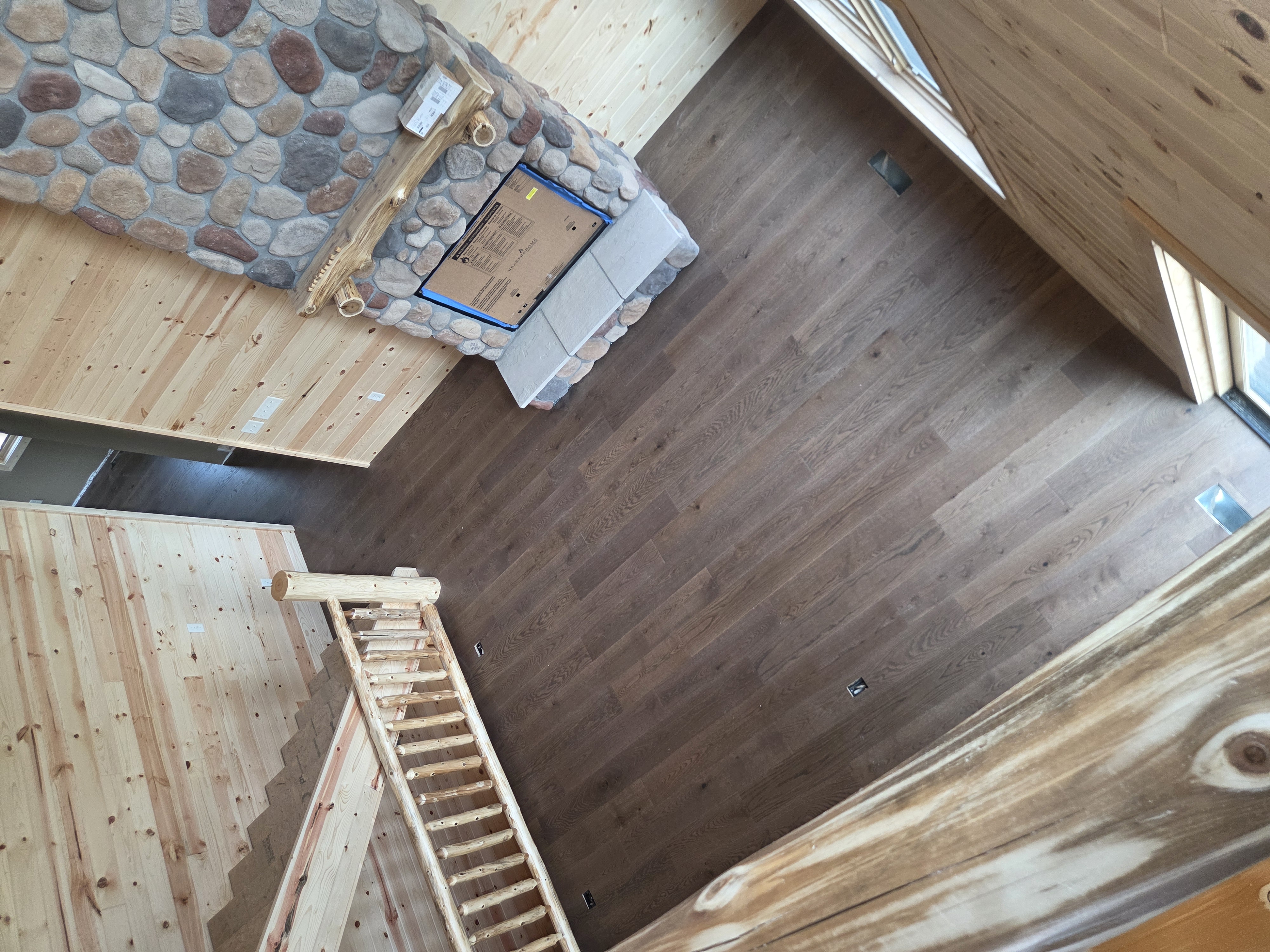 Engineered hardwood flooring in a sunlit loft with lake views