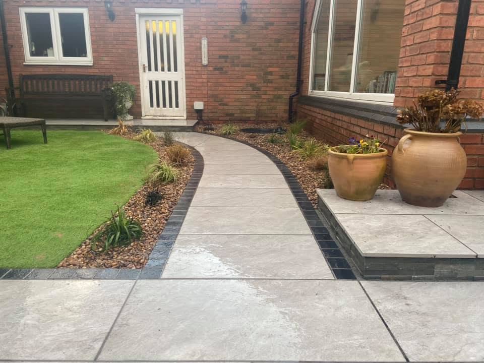 Curved paved pathway with dark sett edging