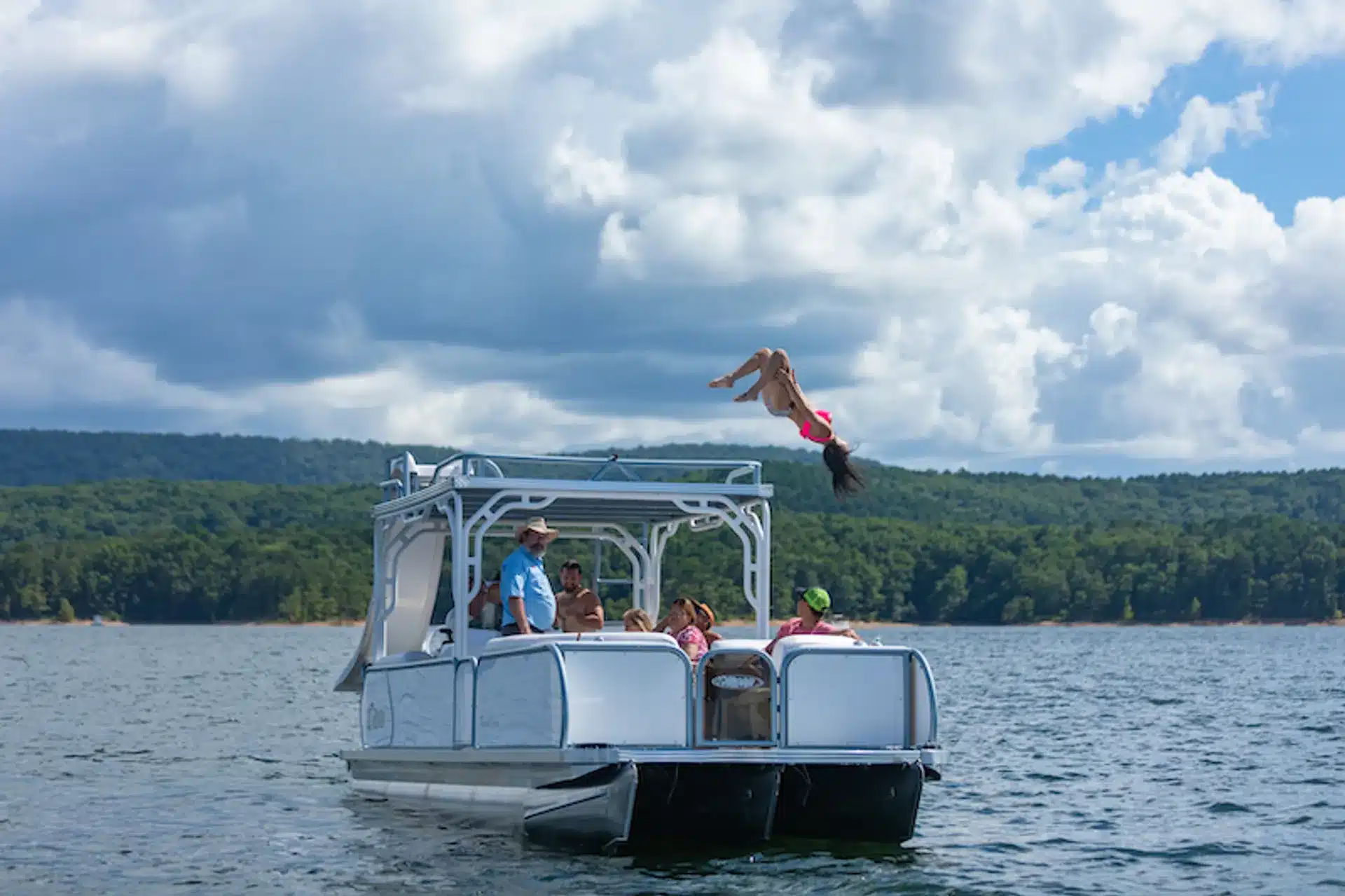 Boats cruising the clear blue waters of Canyon Lake, Texas near Cranes Mill Marina with surrounding Hill Country hills