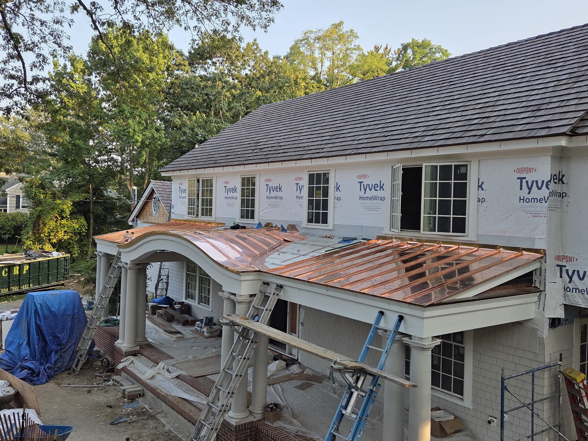 Hand-formed standing seam copper roof installed on a residential porch