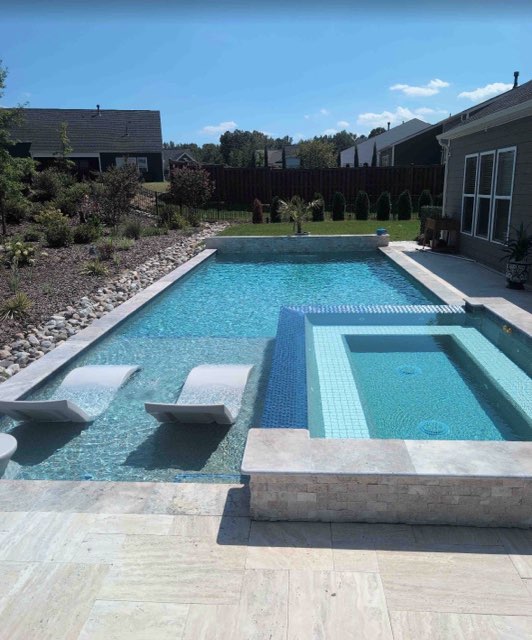 Finished custom swimming pool and integrated spillover spa
