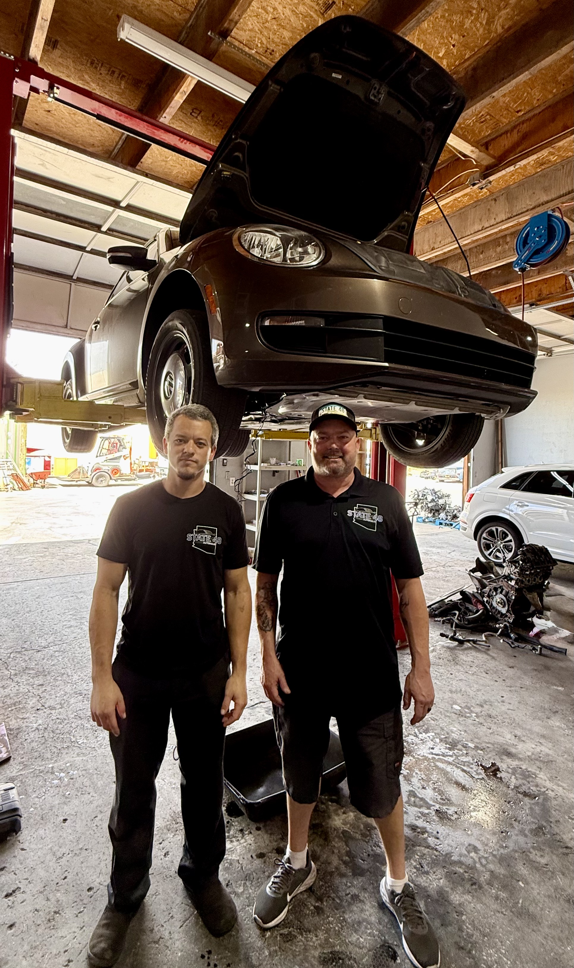 State 48 Autohaus technicians working with a Volkswagen in the Phoenix shop