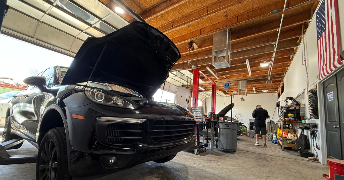 Porsche Cayenne being serviced on a lift at State 48 Autohaus in Phoenix