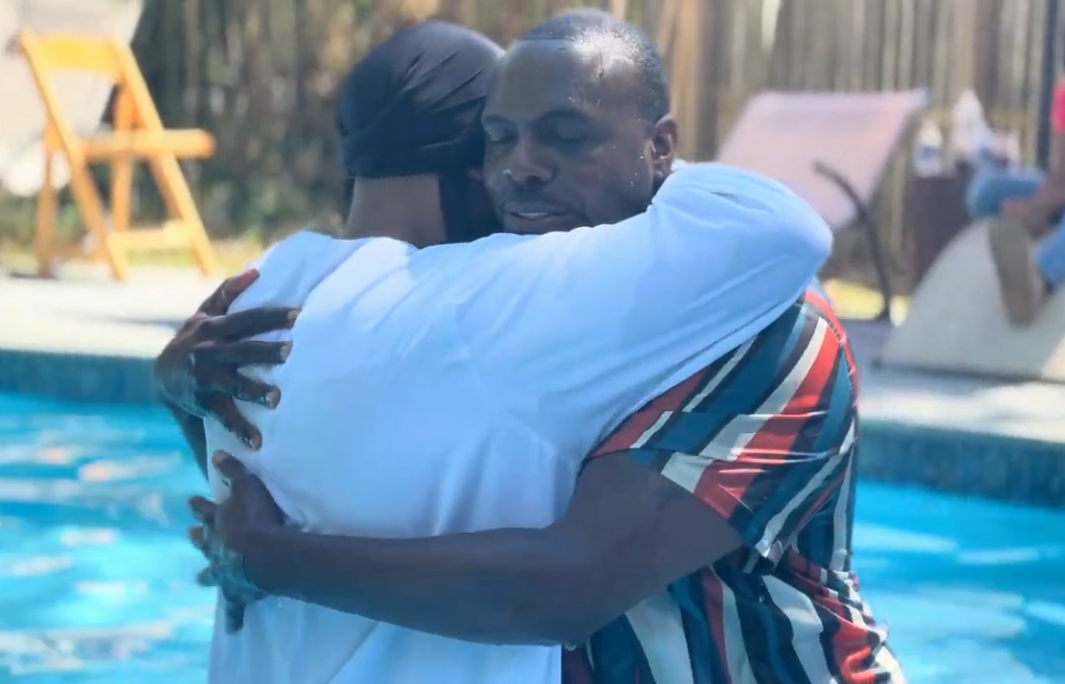 Brother Deshone embracing a brother in baptismal covenant