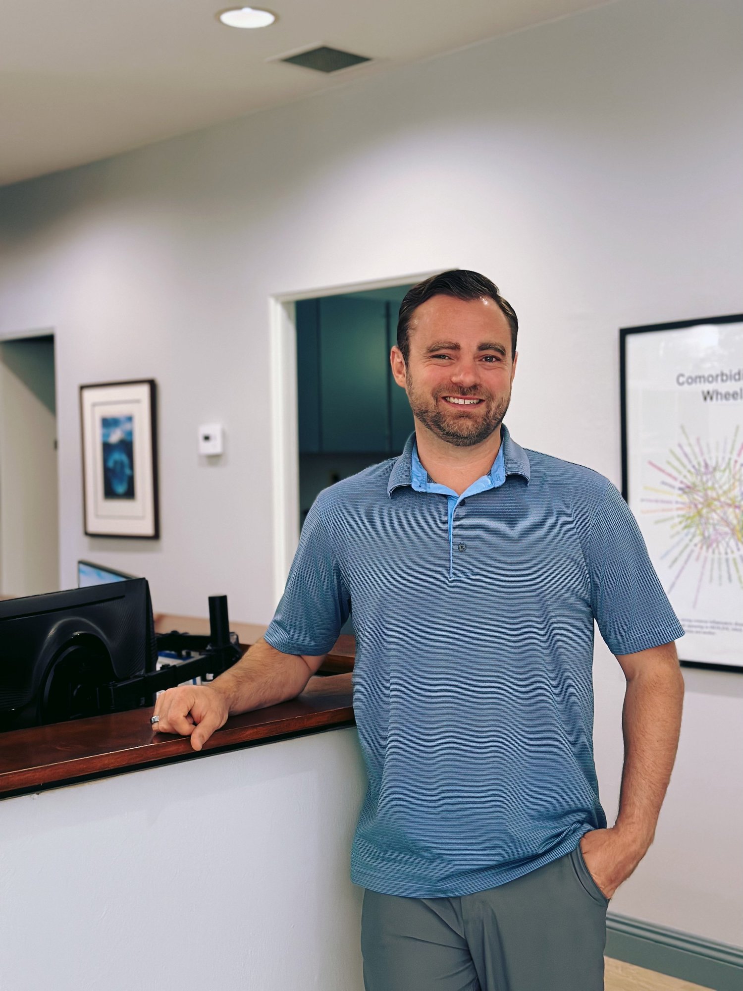 Dr. Scott Kirchner, D.C., at the front desk of Monarch Bay Chiropractic