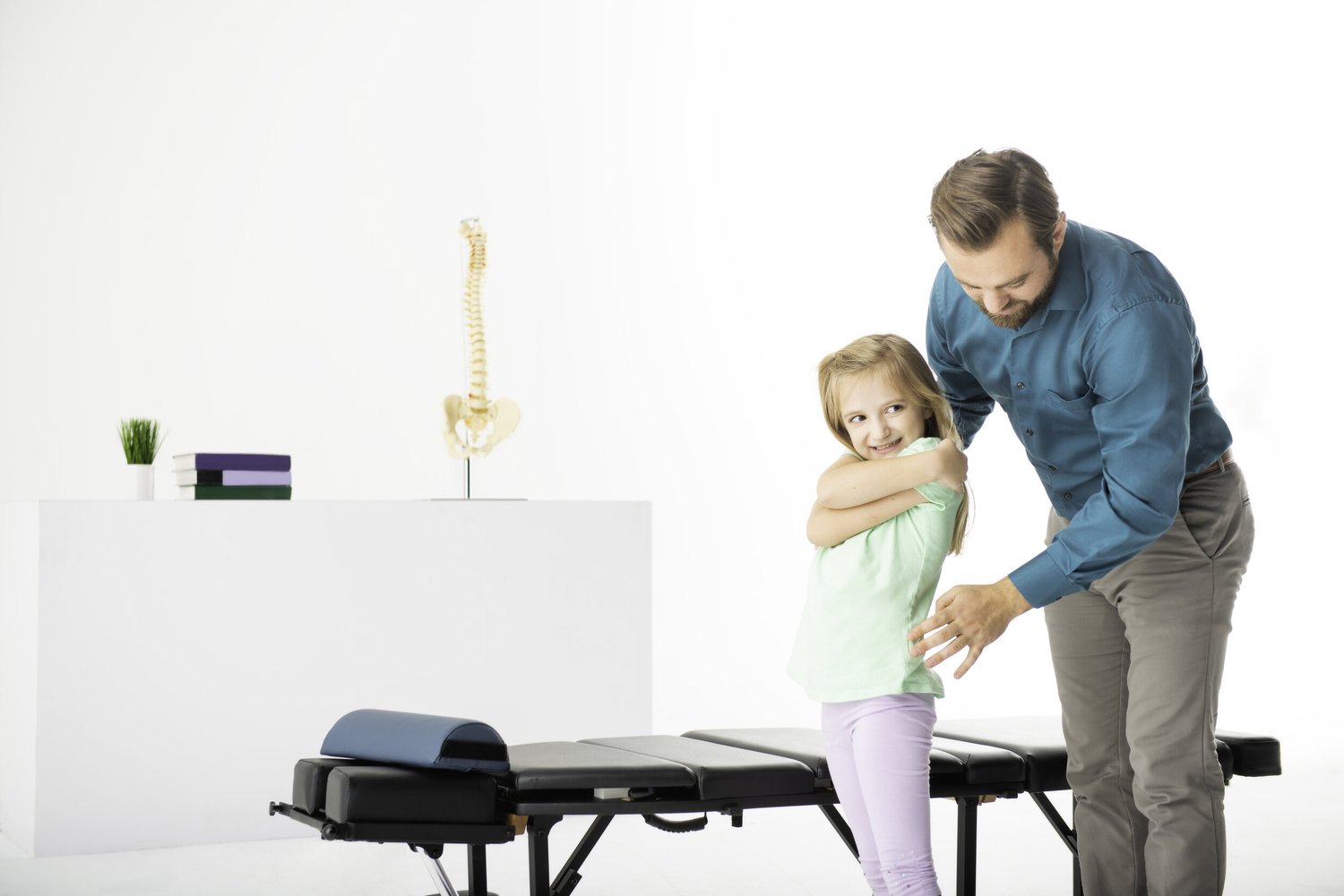 Dr. Scott Kirchner checking a young patient's posture