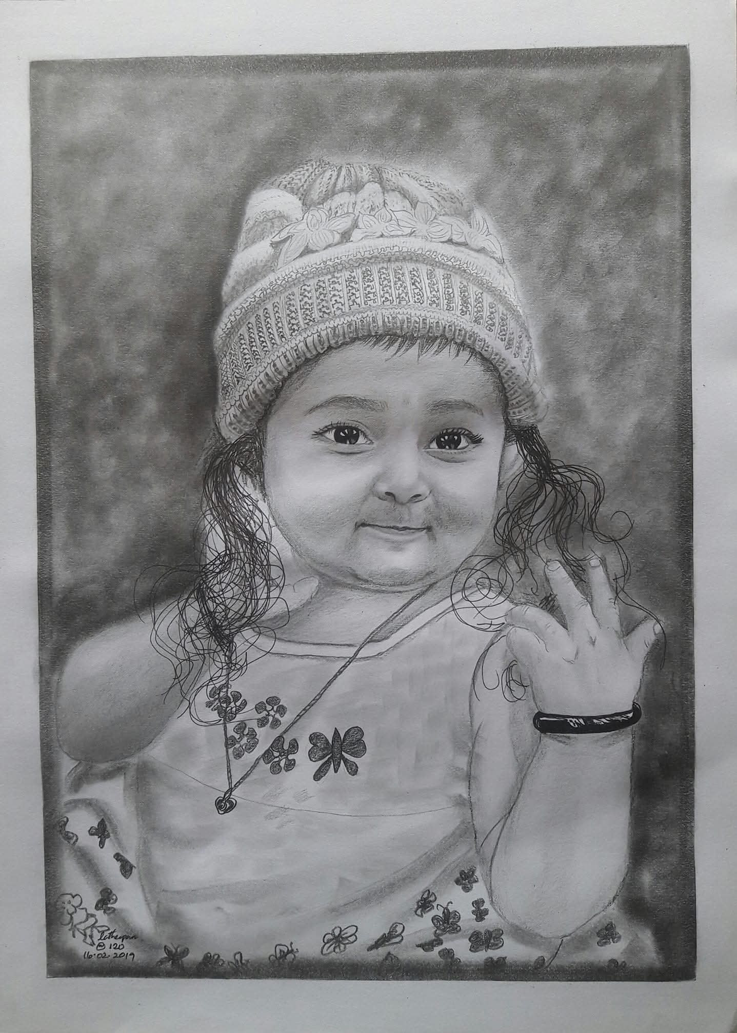 Young girl wearing a knitted hat with butterfly details, signed Latheepan 16.02.2019