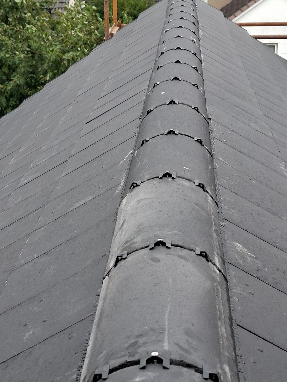 Precision ventilated dry ridge system installed on dark slate roof by Smart Roofing Glasgow