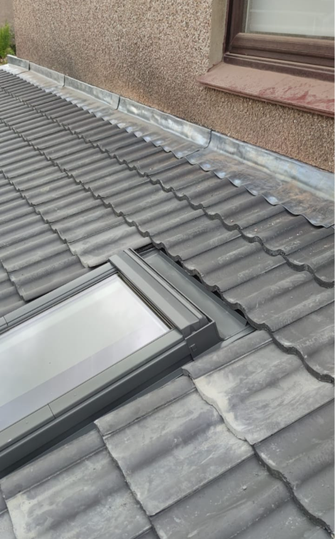 Velux skylight installation with stepped lead flashing abutment wall by Smart Roofing Glasgow