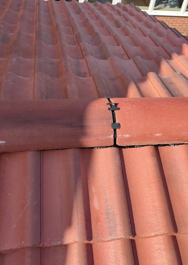 Dry ridge system with interlocking terracotta pantiles by Smart Roofing Glasgow