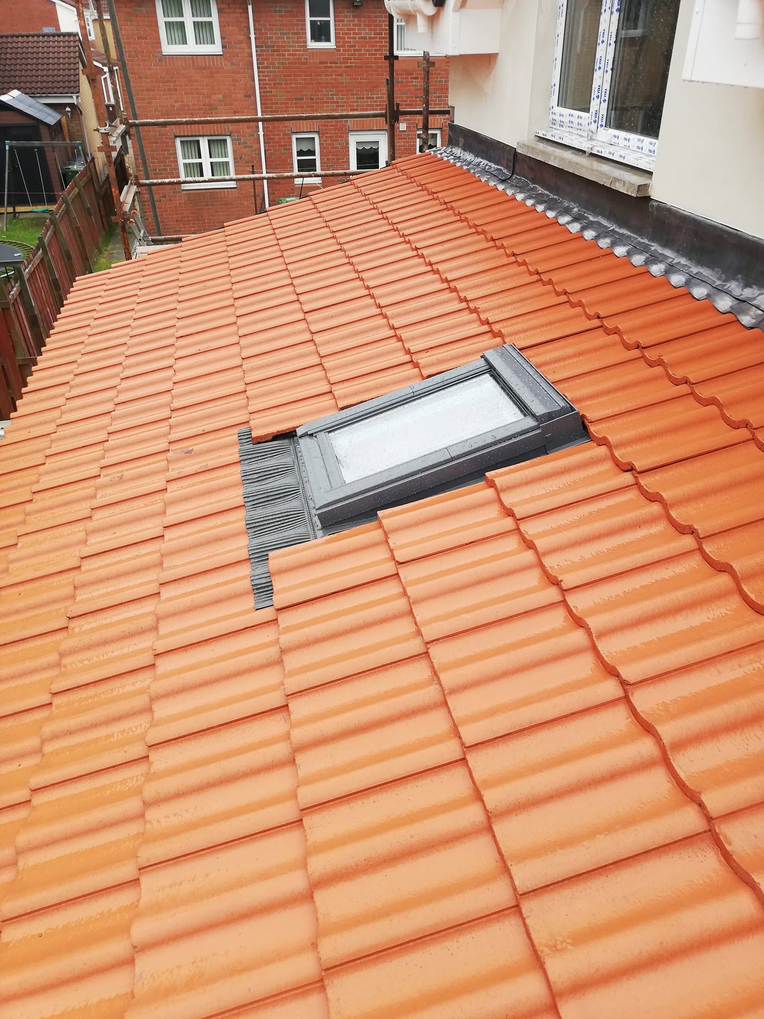 Terracotta roof tiling and Velux window installation by Smart Roofing Glasgow