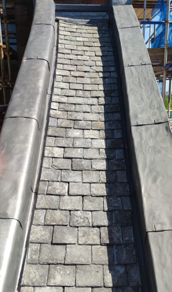 Bespoke lead flashing and dressed slate gully detail by Smart Roofing Glasgow