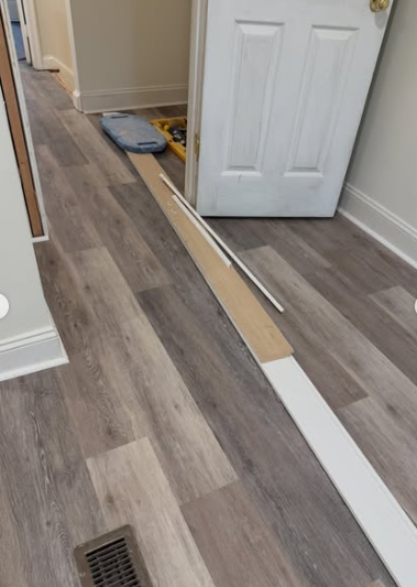 Flooring and trim installation in hallway