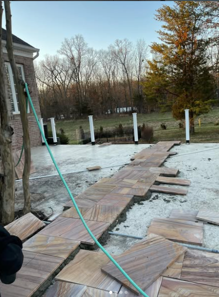 Concrete foundation prep and outdoor stone installation progress
