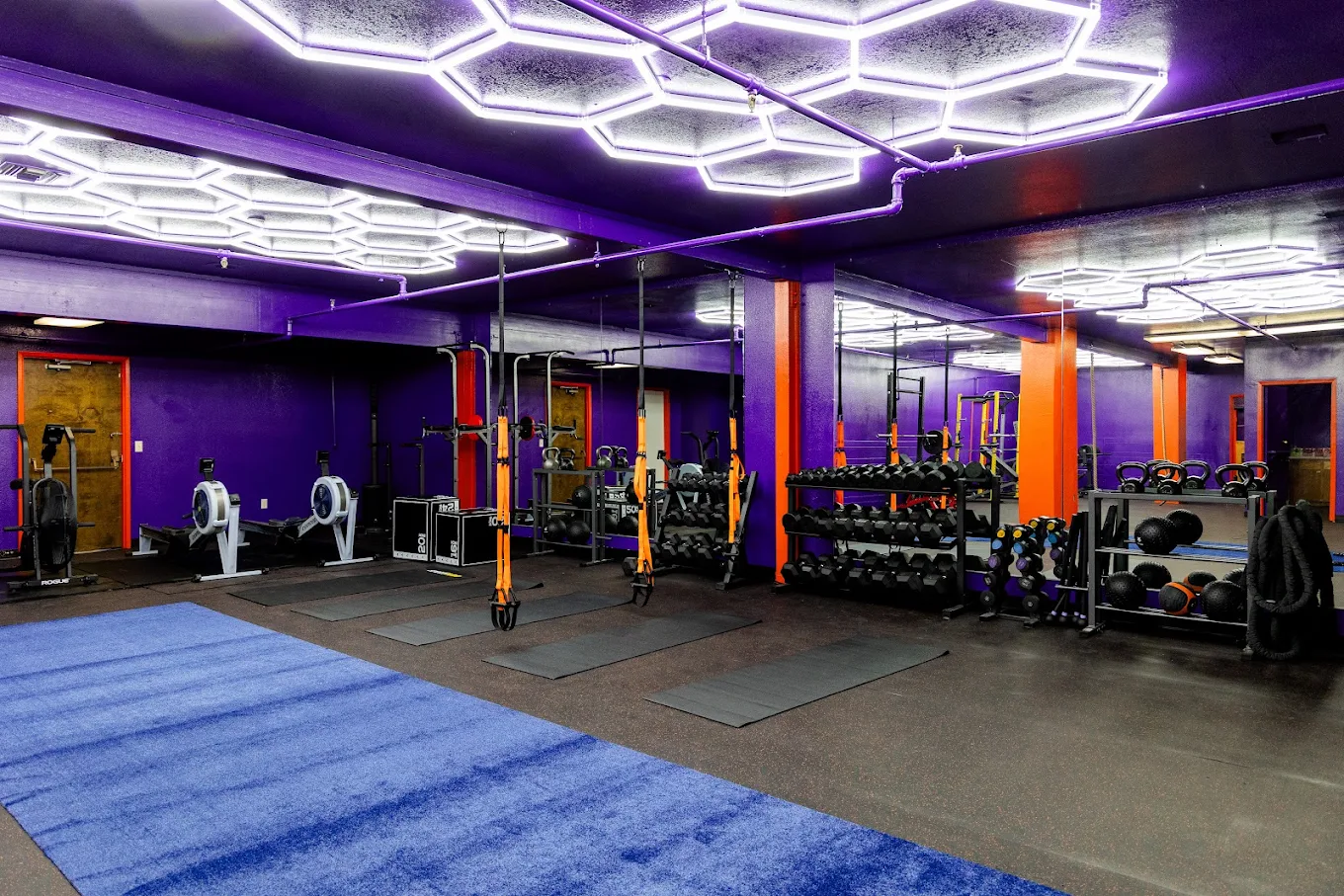 Inside Spite Fitness facility showing warm, clean, open group training environment