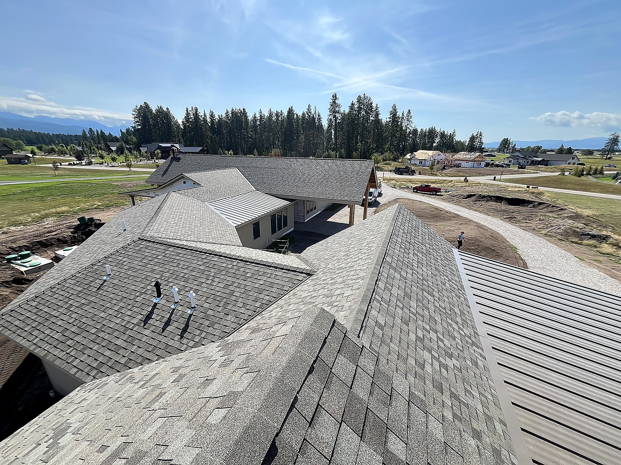 Shingle ridge alongside a standing seam metal roof, Flathead Valley, Montana