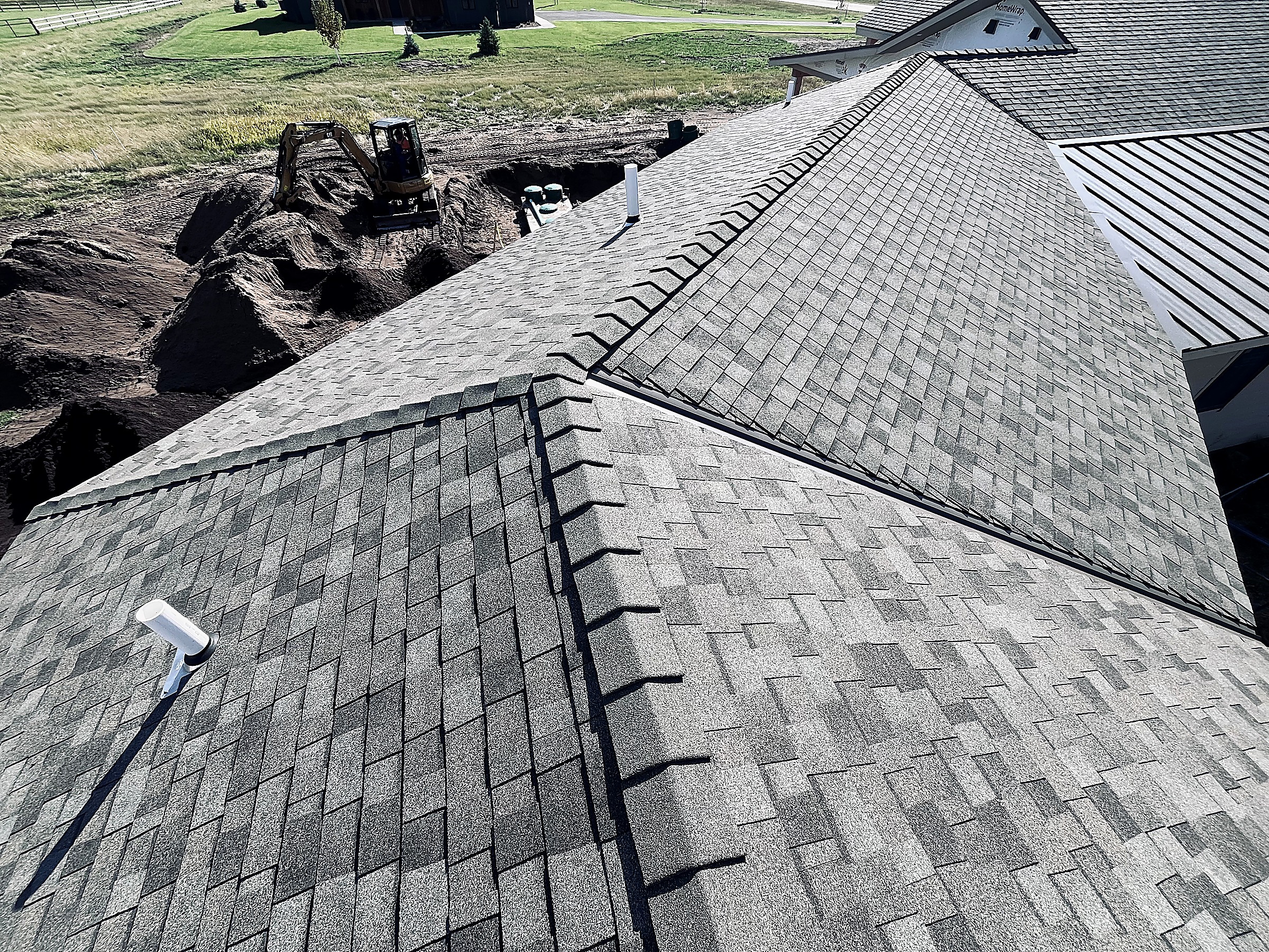 Asphalt shingle roof with hips and a metal roof section, Flathead Valley, Montana