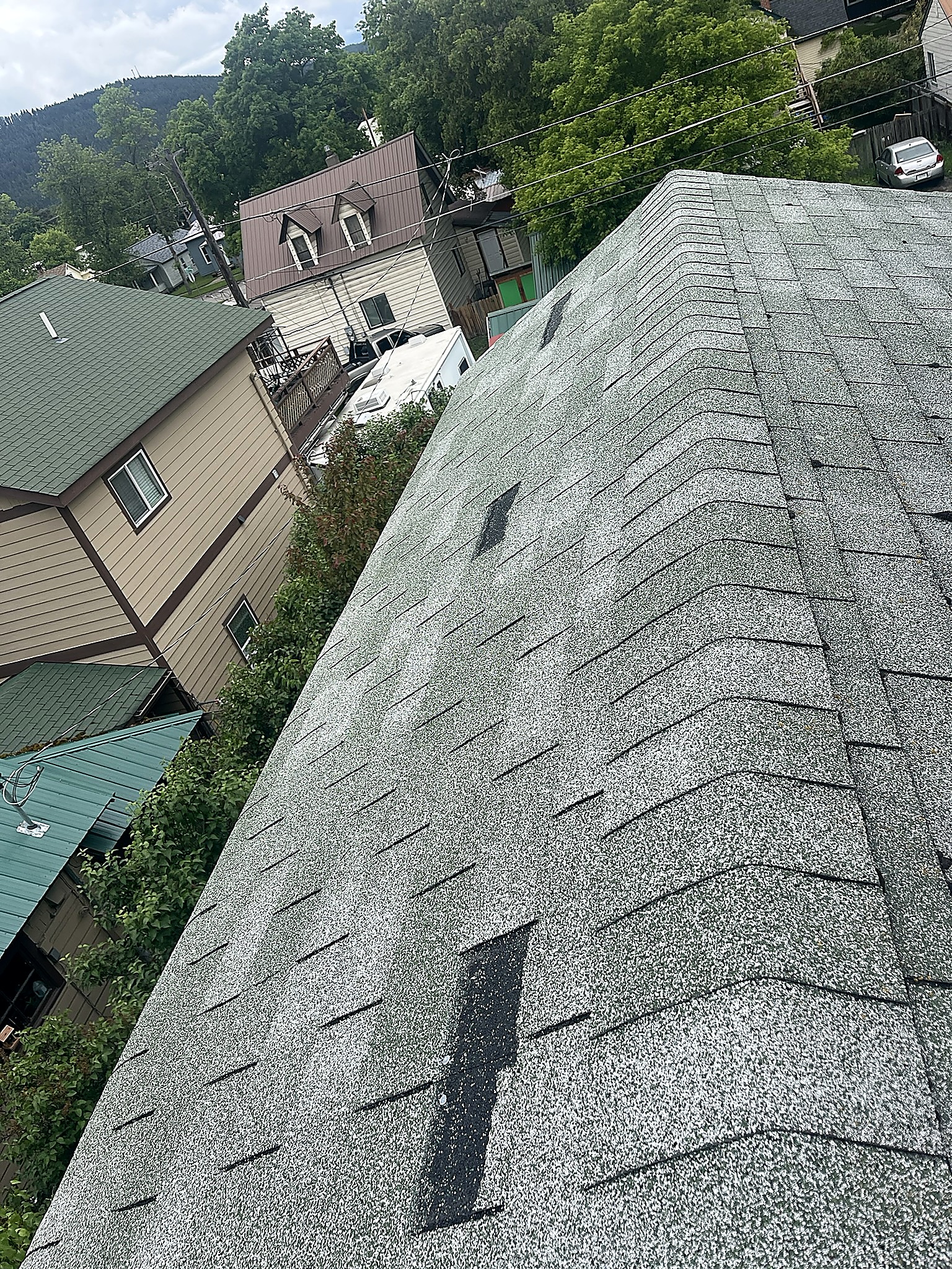 Asphalt shingle roof repairs on a home in Kalispell, Montana