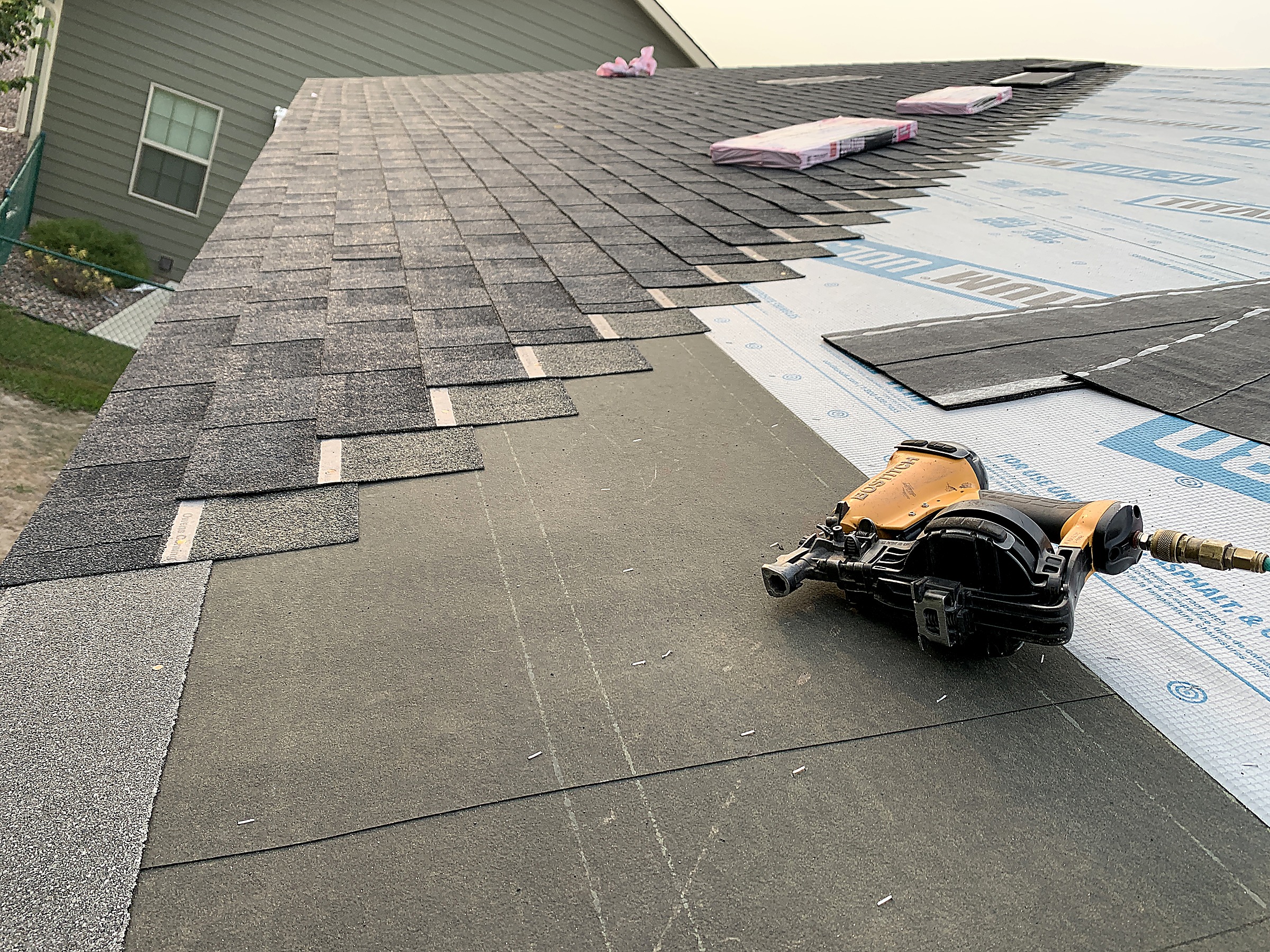 Asphalt shingles being installed over underlayment, Flathead Valley, Montana