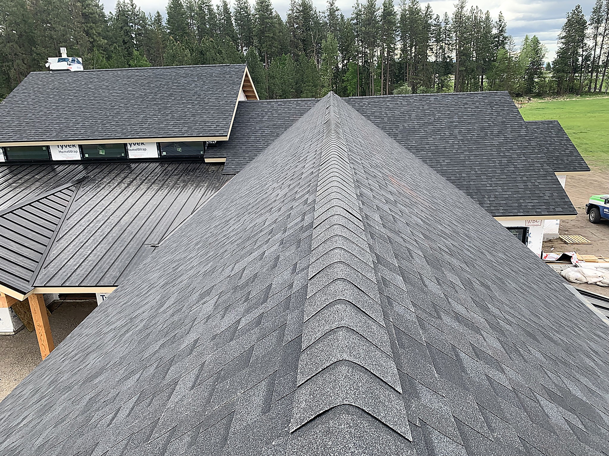 Shingle hip and ridge alongside standing seam metal roofing, Flathead Valley, Montana