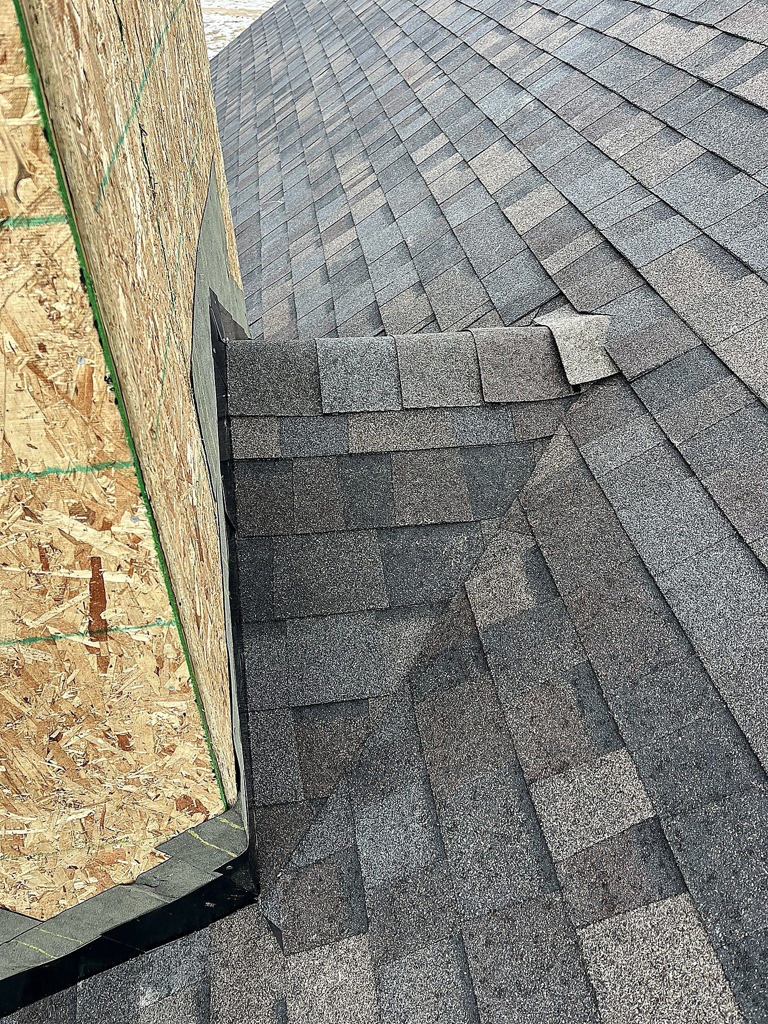 Shingle detail at a wall transition on a roof in the Flathead Valley, Montana
