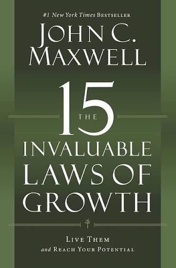 Physical copy of The 15 Invaluable Laws of Growth by John C. Maxwell, included with enrollment.