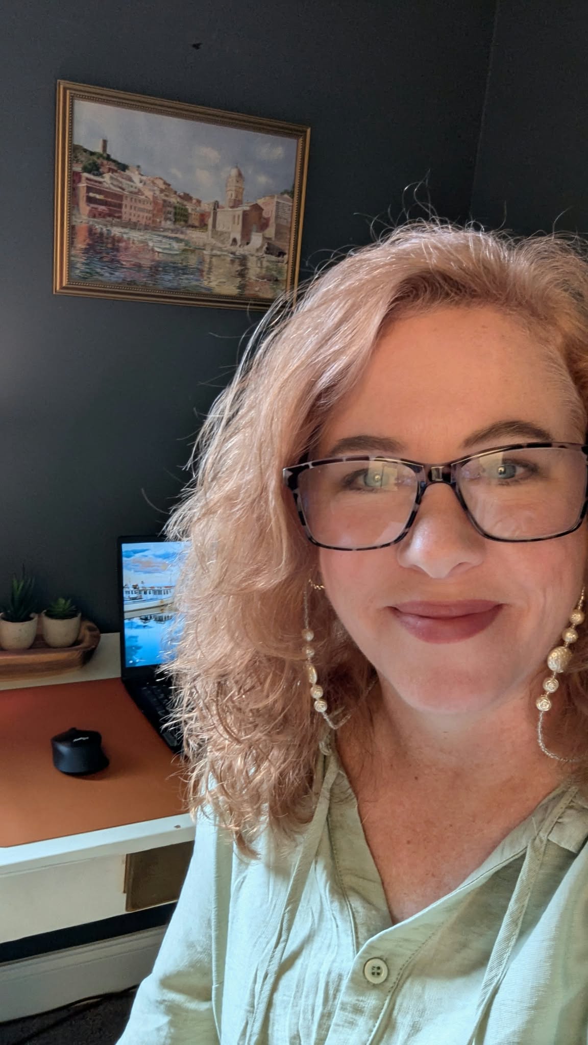 Teresa in a green blouse in her home studio