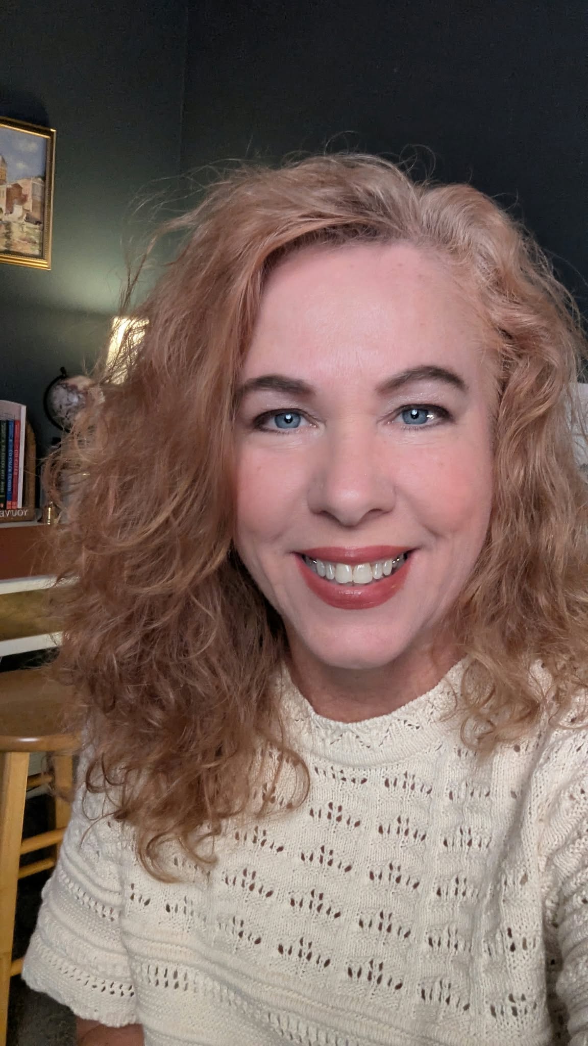 Teresa McKelvey smiling in a cream knit sweater