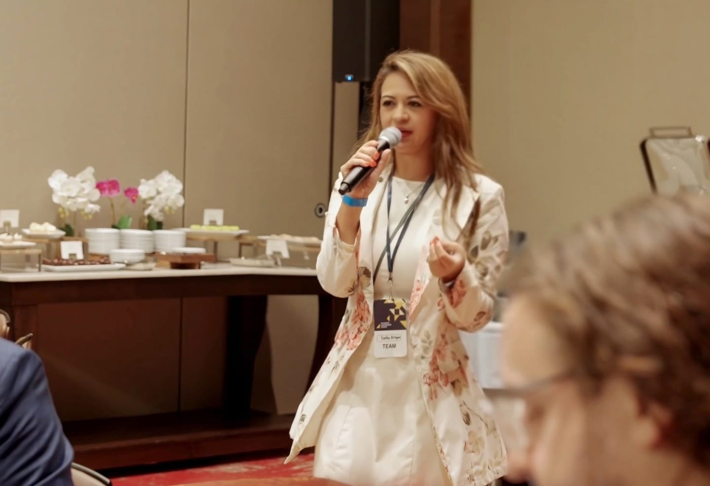 Sasha speaking at a live experience