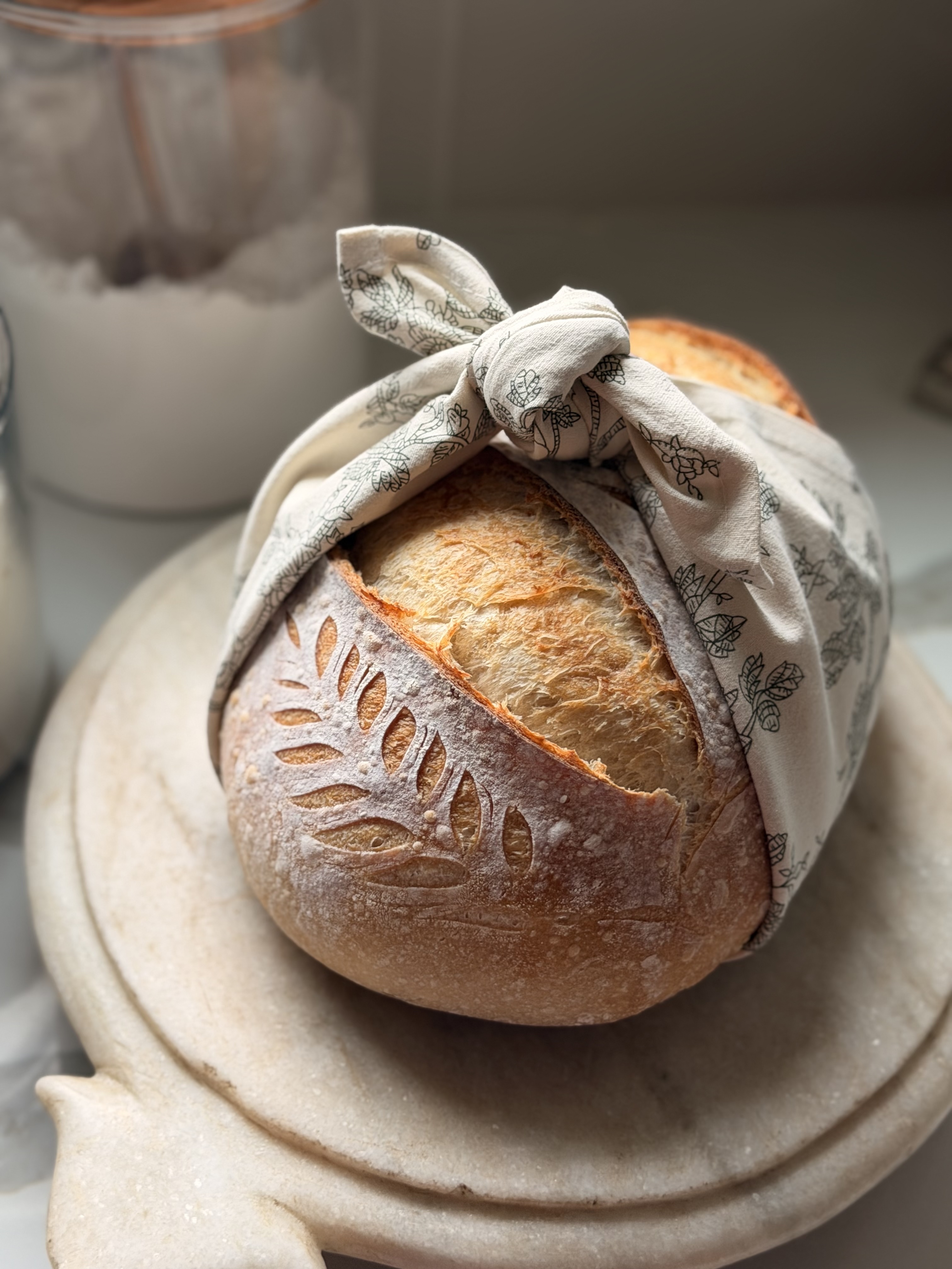 Curated celebration gift basket with signature artisan sourdough, gourmet soups, and baby booties