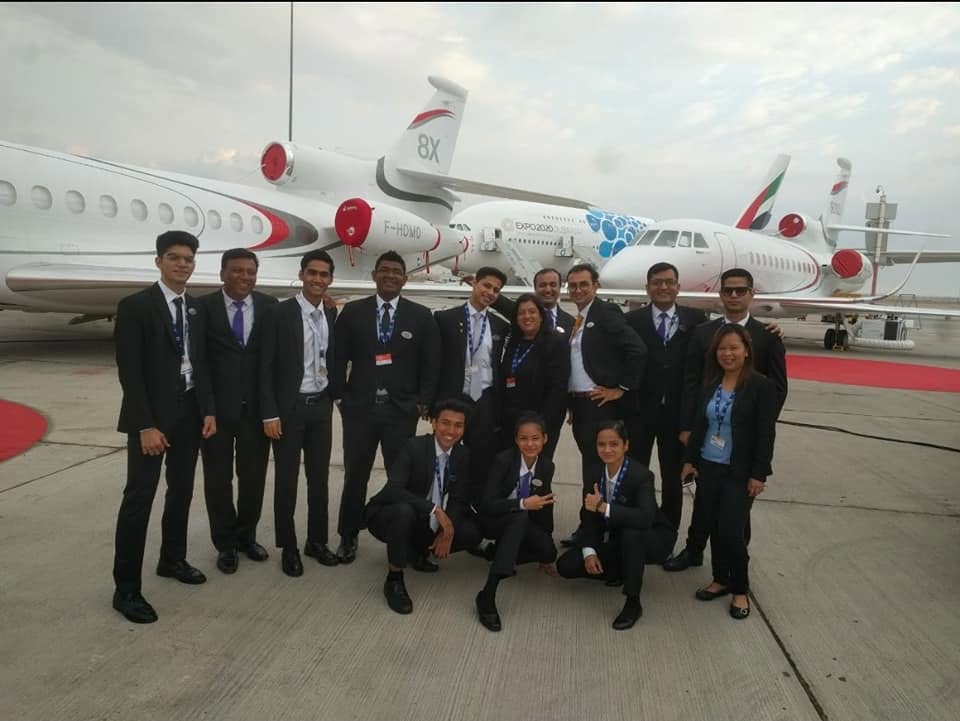 Nitesh Chandel and the floor operations crew on the tarmac by the aircraft