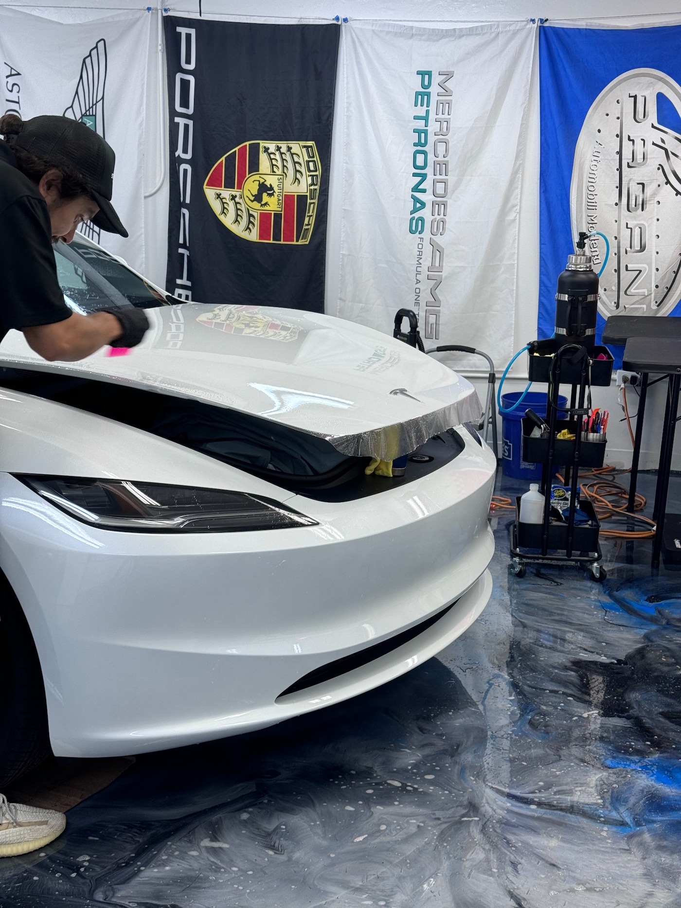 Hood coverage and squeegee prep in a controlled studio bay