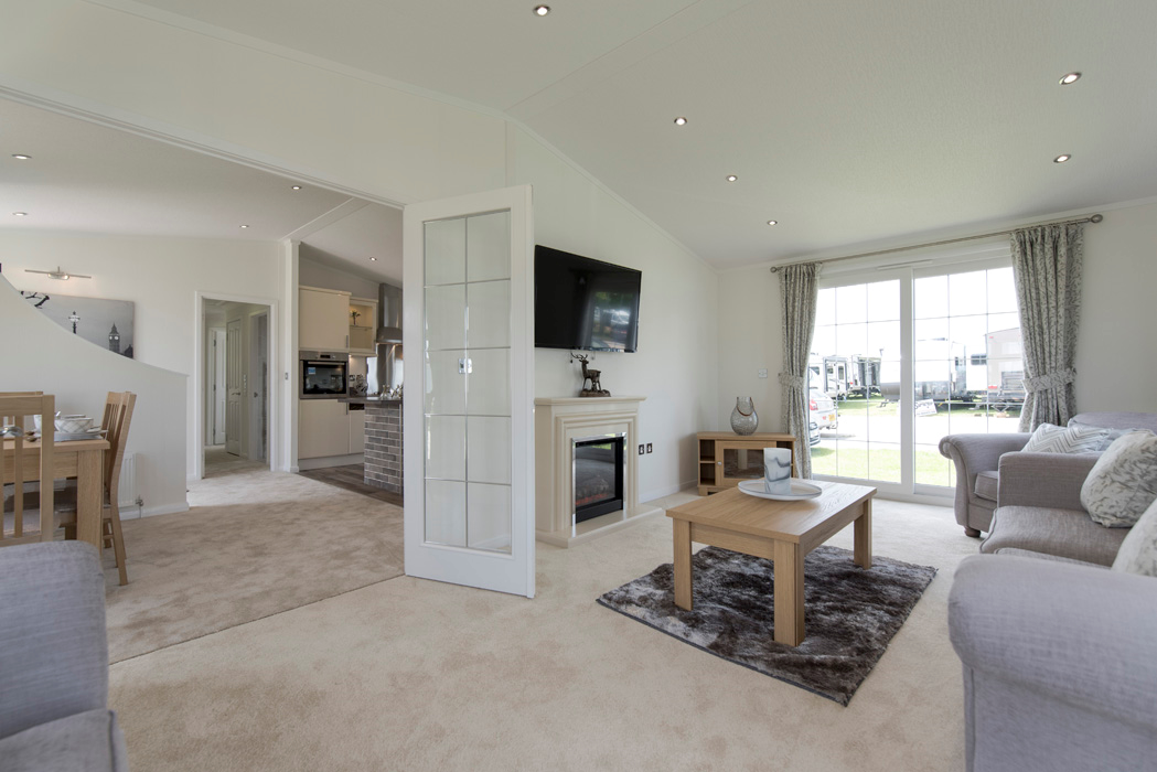 Luxury open-plan park home interior with modern kitchen and french doors