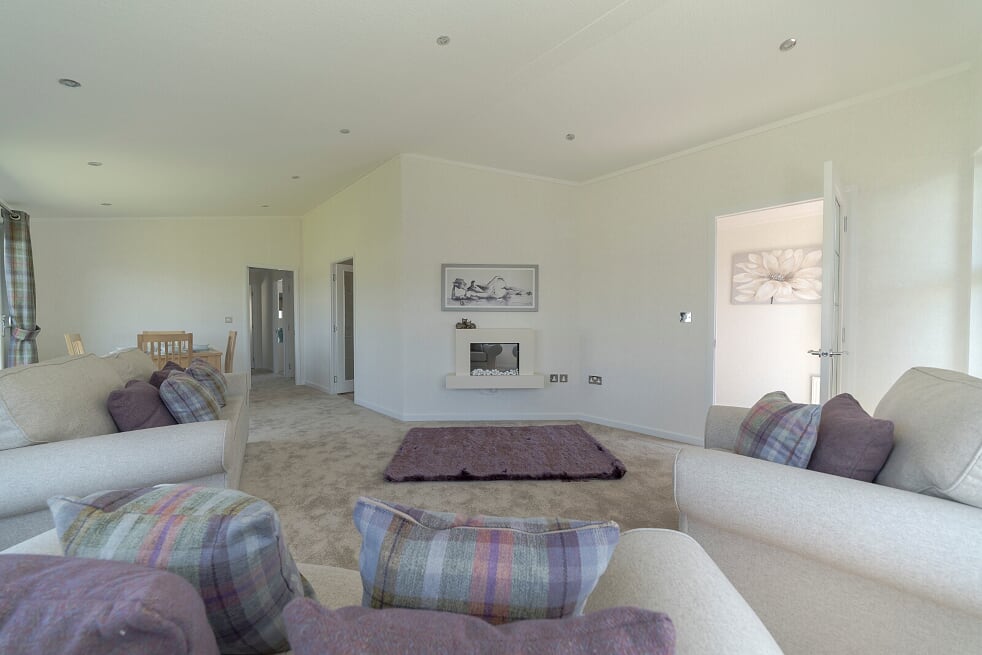 Elegant and comfortable living room with fireplace and countryside views