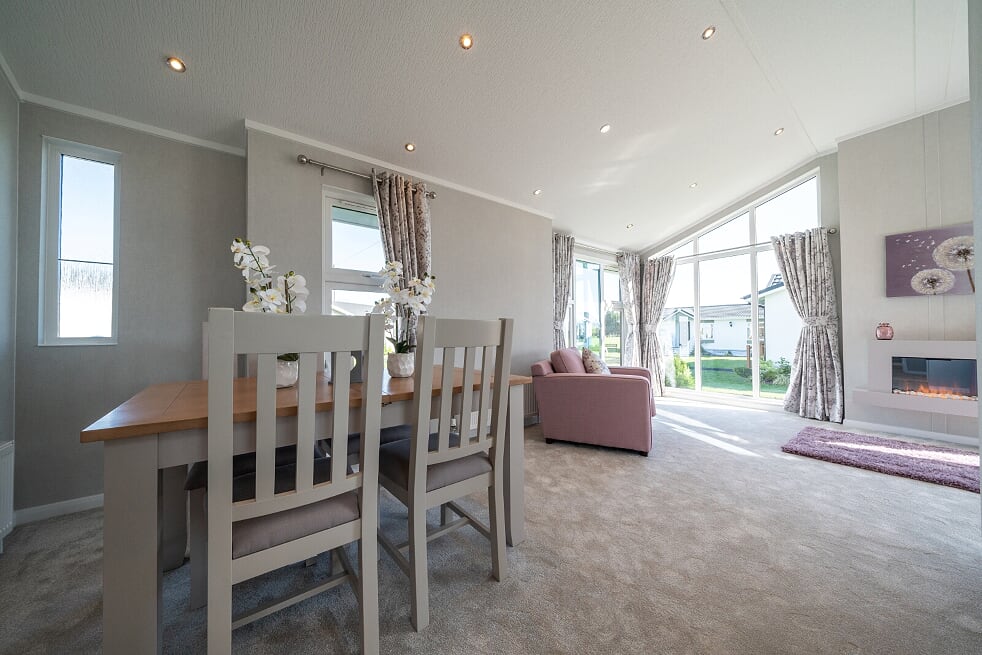 Bright dining room with full-height picture windows looking out onto countryside
