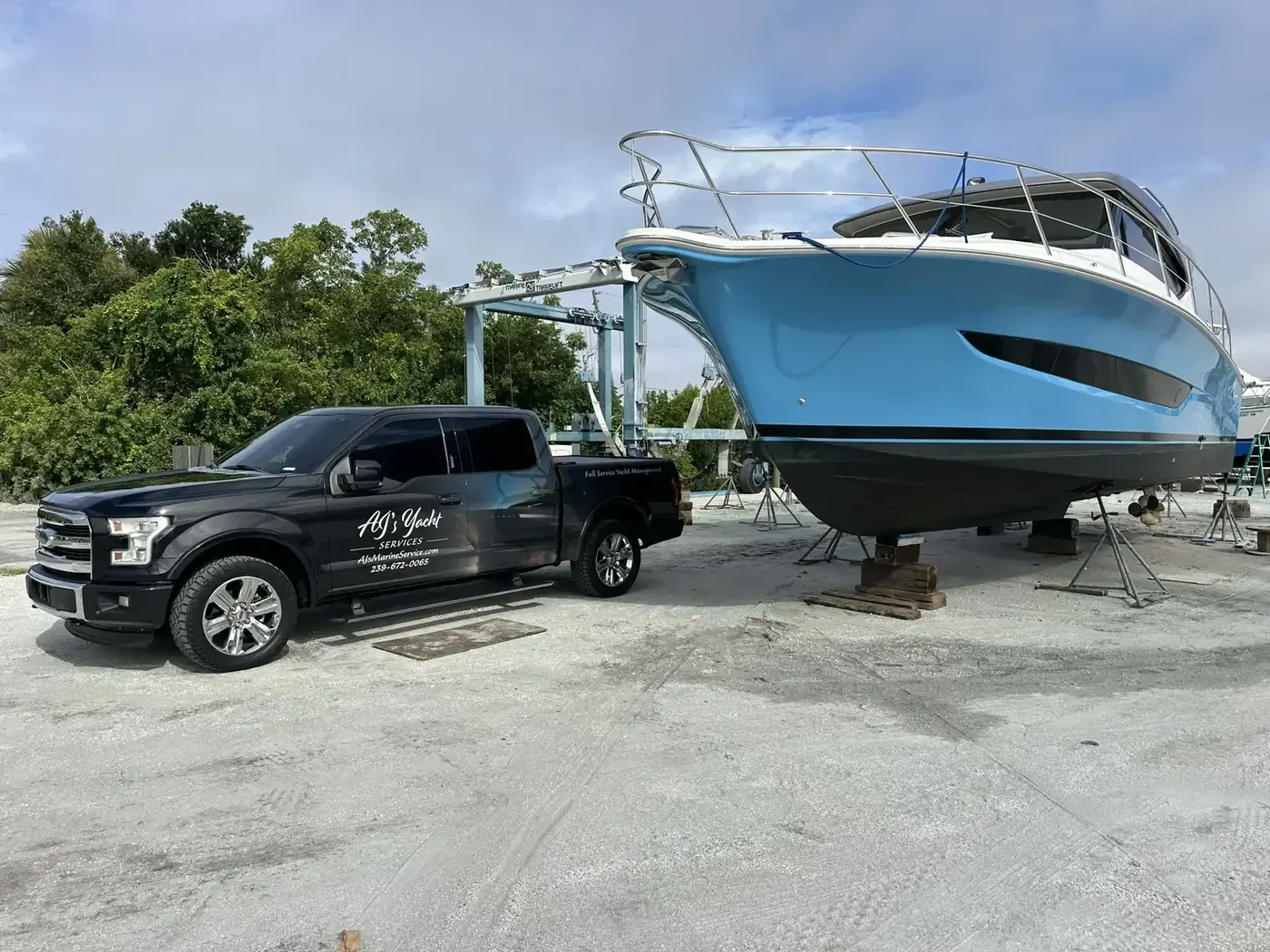 AJ's Yacht Service vehicle and vessel on stands