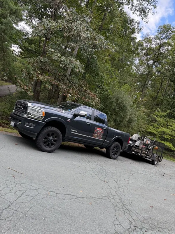 Austins Mowing & Mechanical Services truck towing a zero-turn mower, Culpeper VA