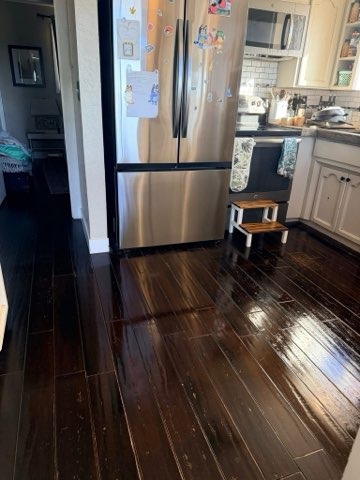 Stainless steel refrigerator and kitchen dark hardwood floor in Redmond OR