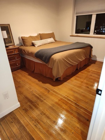 Polished honey wood floor and master bedroom in Sisters OR