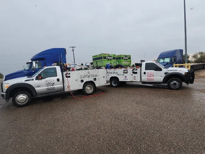 RoadRunner 24 HR Road Service crane-equipped mobile repair trucks on a West Texas roadside job