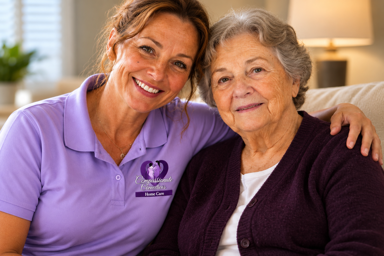 Compassionate caregiver wearing a lavender brand polo with logo embracing senior woman in Charlotte, NC