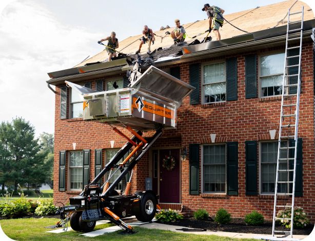 Equipter 4000 elevated to the roofline of a residential home catching tear-off debris