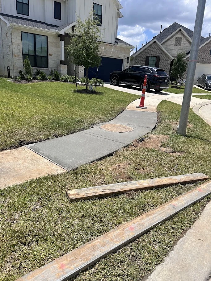 Freshly poured curved concrete sidewalk in an Orange-area neighborhood