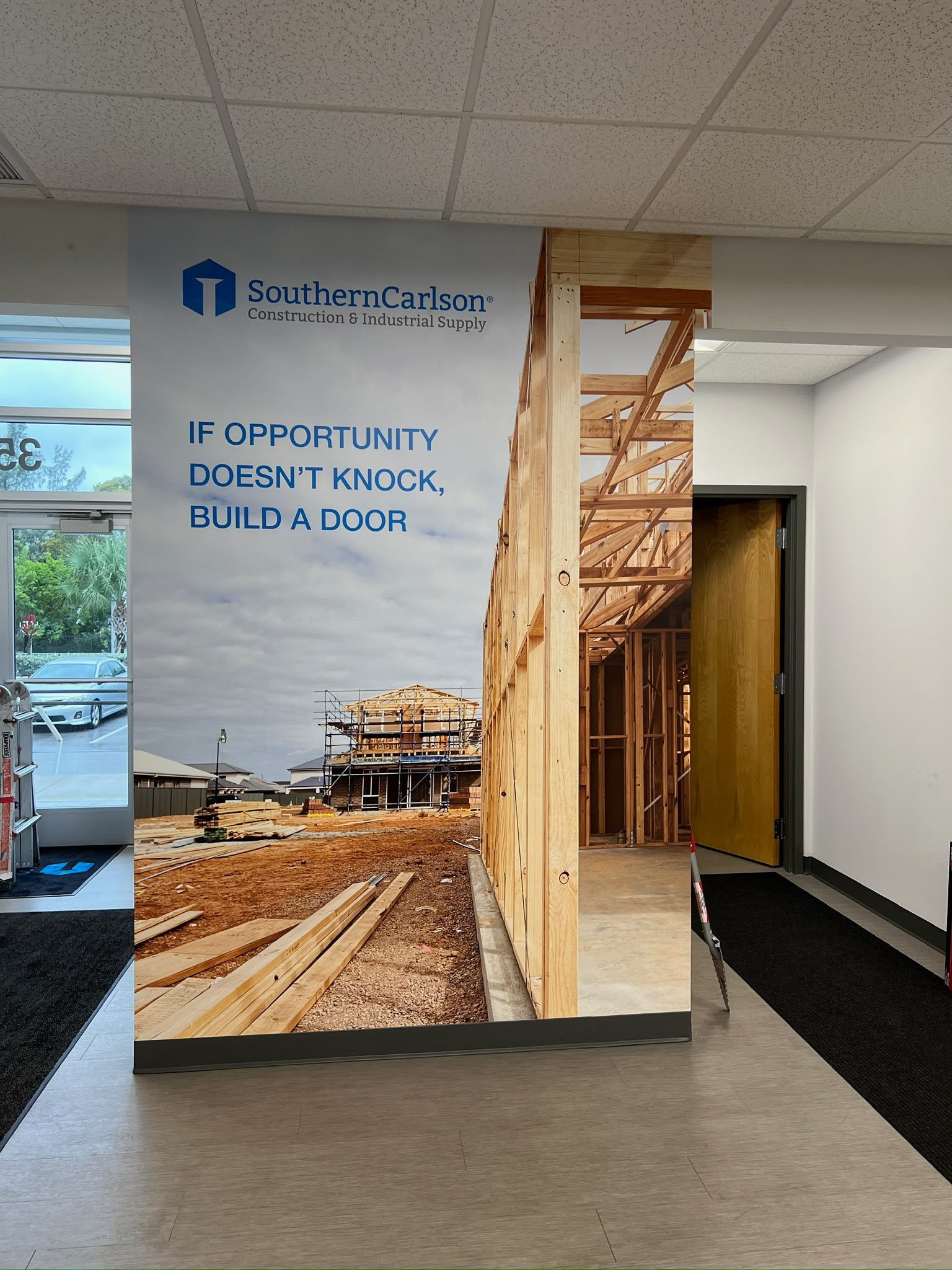 SouthernCarlson entrance lobby architectural column graphic wrap with construction photography in Doral FL