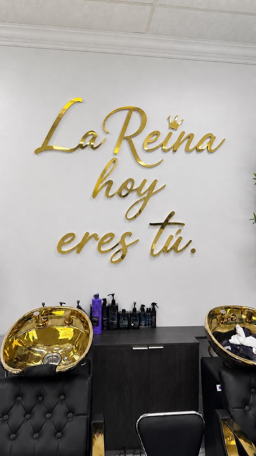 Custom gold mirror script wall lettering installed for beauty salon in Kendall FL