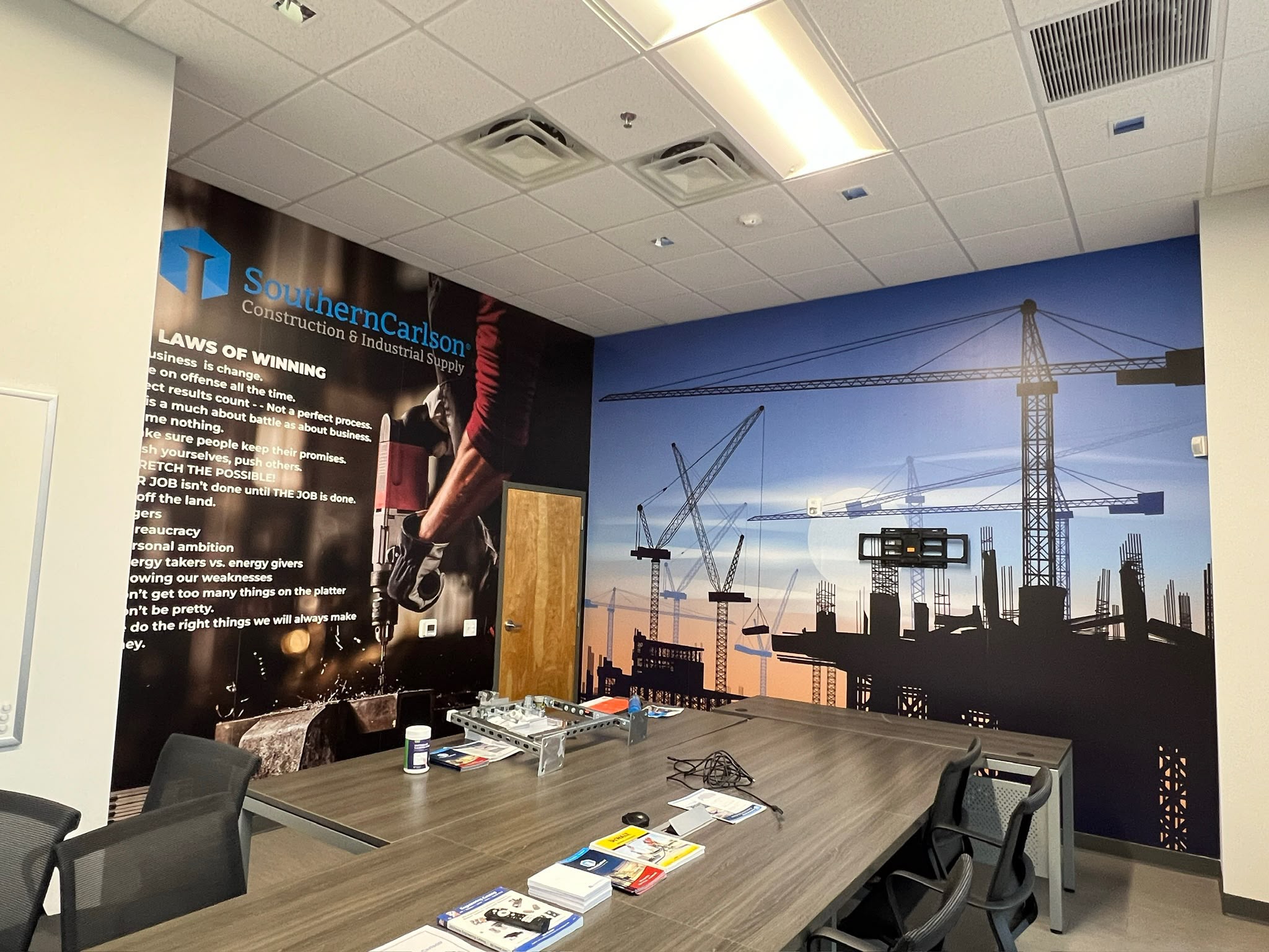 Dual-wall boardroom commercial wall wrap installation with construction cranes skyline and corporate values in Doral FL